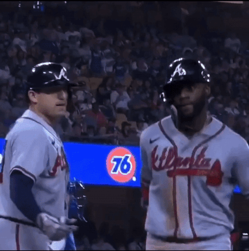 Two Baseball Players Wearing A Jersey That Says Atlanta GIF