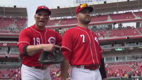Two Baseball Players Wearing Red Uniforms With The Number 19 On The Front GIF