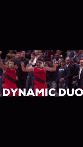 Two Basketball Players Are Celebrating In Front Of A Crowd With Dynamic Duo Written In White GIF
