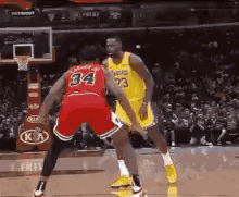 Two Basketball Players Are Playing A Game Of Basketball . GIF