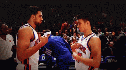 Two Basketball Players From The New York Knicks Standing Next To Each Other GIF