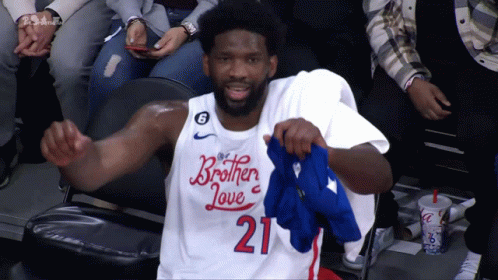 Two Basketball Players In Blue 76Ers Shirts GIF