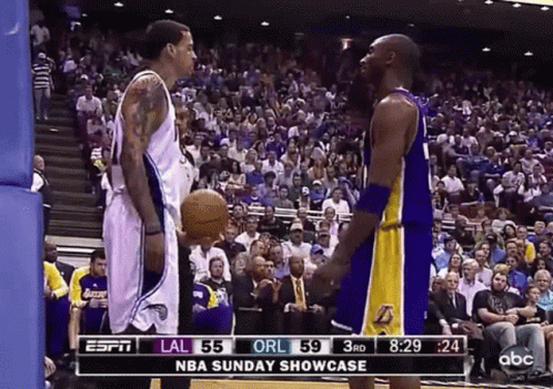 Two Basketball Players in Front of Crowd