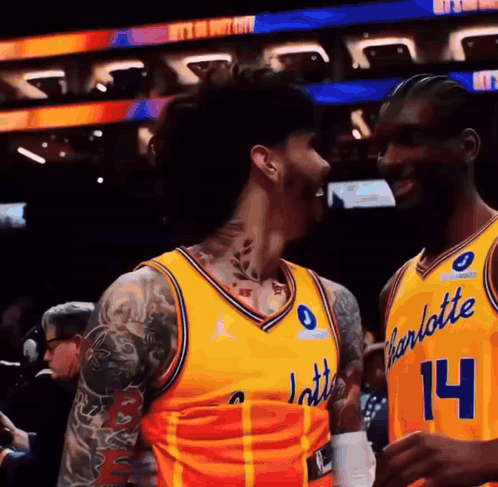 Two Basketball Players in Yellow Charlotte Uniforms