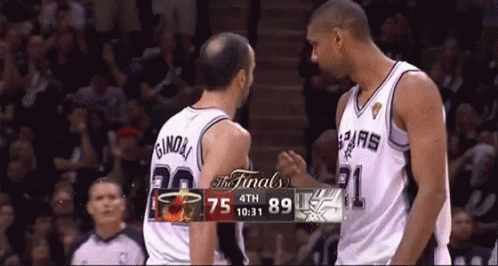 Two Basketball Players Near Scoreboard GIF