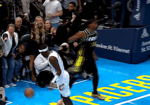 Two Basketball Players On Court With Crowd GIF