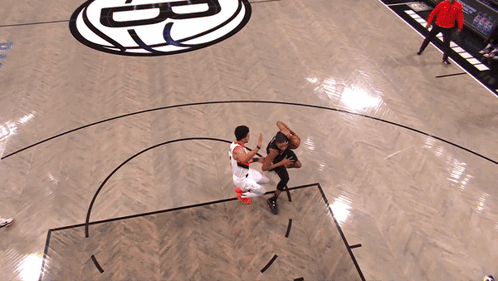Two Basketball Players on Court with Letter B