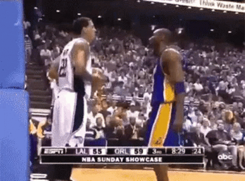 Two Basketball Players Standing In Front Of Crowd GIF