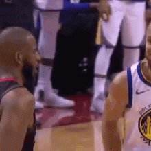 Two Basketball Players Standing Together on Court