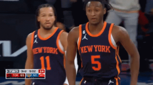 Two Basketball Players Wearing New York Uniforms Are Standing On The Court GIF