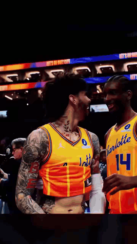 two basketball players wearing yellow jerseys that say charlotte