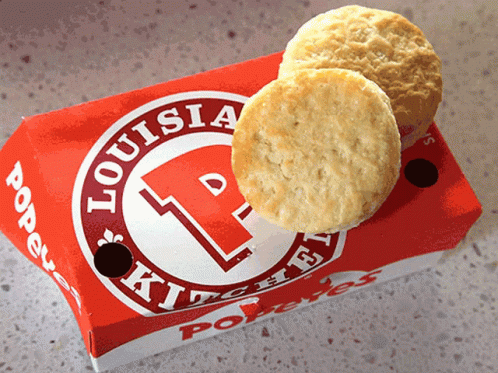 Two Biscuits In A Box That Says Louisia Kitchen On It GIF