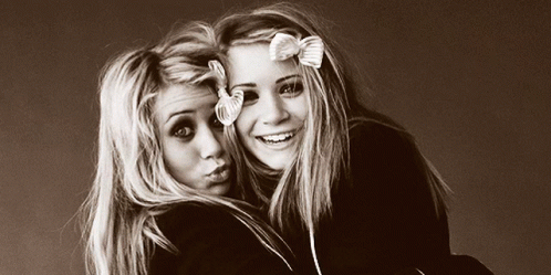 Two Blonde Girls with Bows Posing