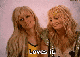 Two Blonde Women Are Standing Next To Each Other And One Of Them Is Saying Loves It GIF