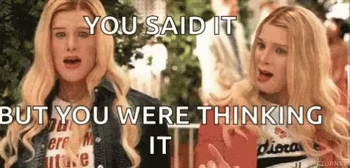 Two Blonde Women Are Standing Next To Each Other And Talking . GIF