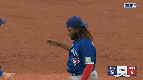 Two Blue Jays Players Shake Hands During A Baseball Game GIF