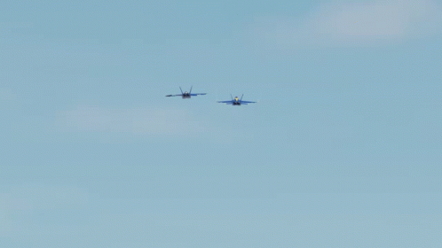 Two Blue Jets Flying In A Blue Sky GIF