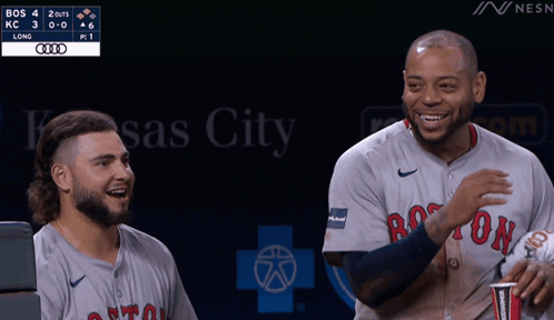 Two Boston Red Sox Players Are Laughing During A Game GIF