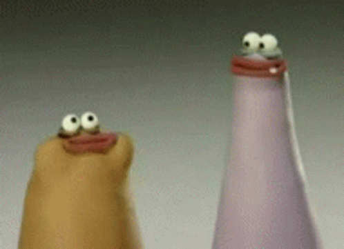 Two Bottles With Googly Eyes Are Sitting Next To Each Other On A Table . GIF