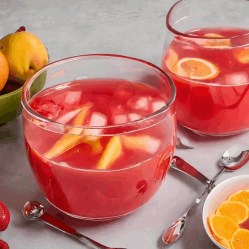 Two Bowls of Punch With Spoons and Fruit Bowl