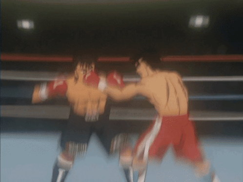 Two Boxers Are Fighting In A Boxing Ring And One Of Them Is Wearing Red Shorts GIF