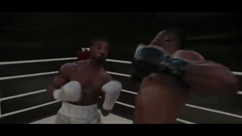 Two Boxers Are Fighting In A Ring With A Sign That Says World Heavyweight Champions On It GIF