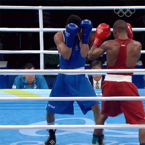 Two Boxers Are In A Ring With One Wearing A Shirt That Says ' Russia ' On It GIF