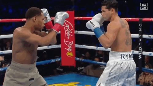 Two Boxers Fighting in Ring With Golden Boy Banner