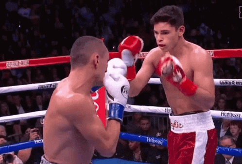 Two Boxers Fighting in Ring With Hennessy Advertisement