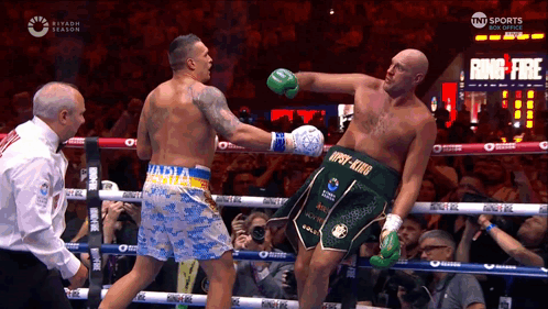Two Boxers Fighting, One Wearing 'npsy-king' Shorts