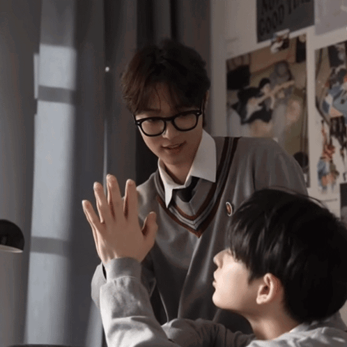 Two Boys Are Giving Each Other A High Five In Front Of A Poster That Says " No Good Times " GIF