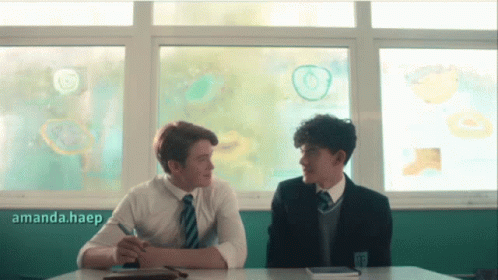 Two Boys Are Sitting At A Desk In Front Of A Window With A Panda.haep Watermark On The Bottom GIF