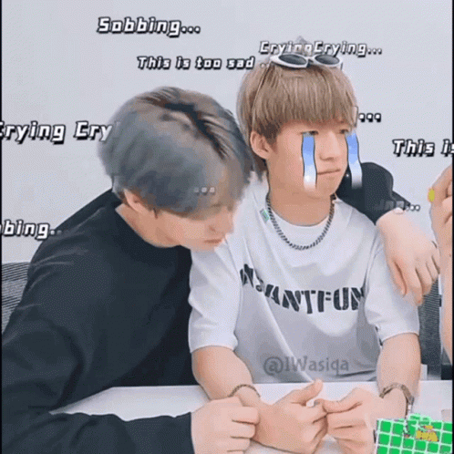 Two Boys Are Sitting Next To Each Other And One Has A Tear Coming Out Of His Eye GIF