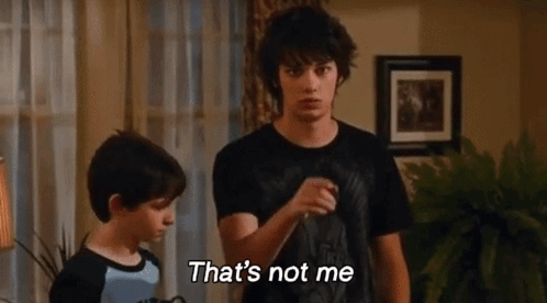 Two Boys Are Standing Next To Each Other In A Living Room And One Of Them Is Saying That 'S Not Me . GIF