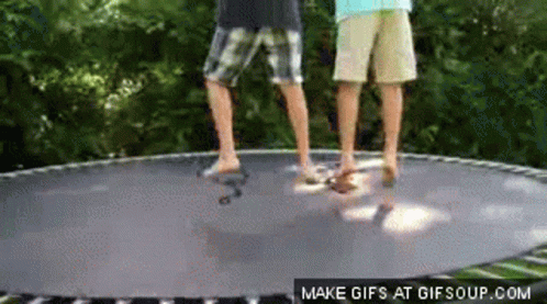 Two Boys Jumping on Trampoline