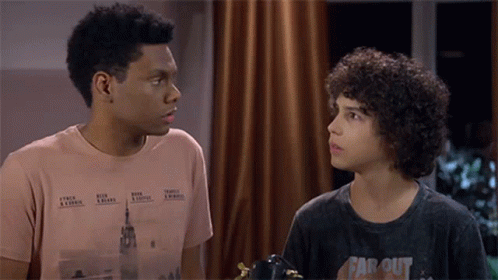 Two Boys Looking At Each Other One In Far Out Shirt GIF