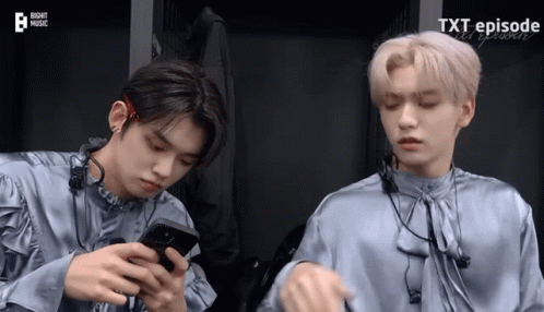 Two Boys Looking at Phones Saying Xt Episode