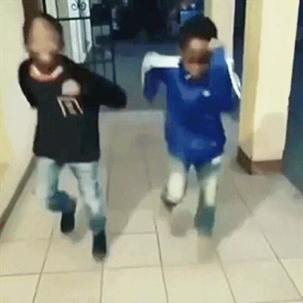 Two Boys Running Down Hallway With Faces Covered