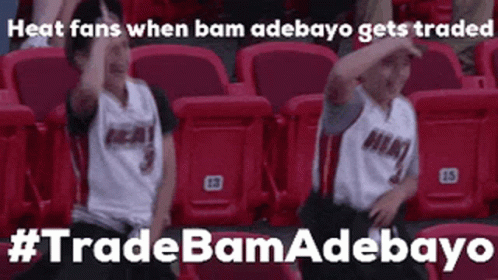 Two Boys Sitting With Arms Up In Stadium GIF