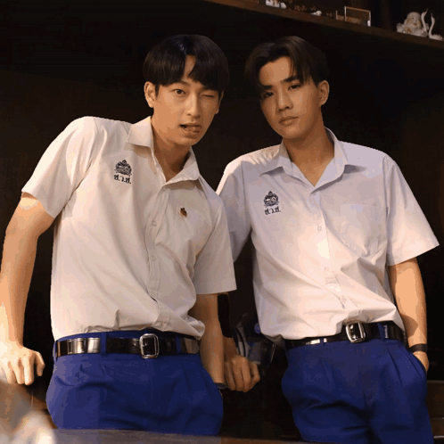 Two Boys Wearing White Shirts With H.i.k. On The Front GIF