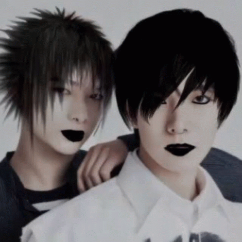 Two Boys With Black Hair And Black Lips Are Posing For A Picture . GIF