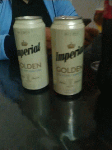 two cans of imperial golden sit on a table