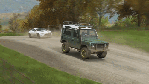 Two Cars Are Driving Down A Dirt Road And One Has A Roof Rack GIF