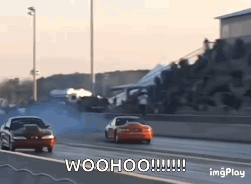 Two Cars Are Racing On A Race Track And The Words Woohoo Are Written On The Screen . GIF