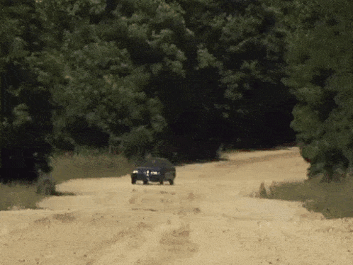 Two Cars Driving Down Dirt Road GIF