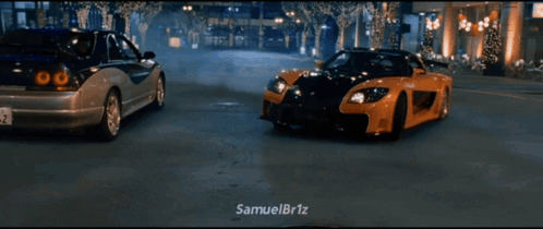 Two Cars Driving Down Street
