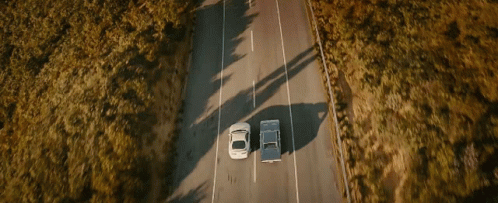 Two Cars Driving With Arrow Pointing Right
