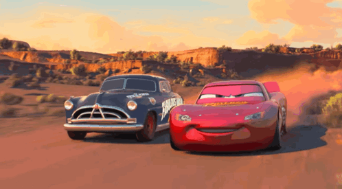 Two Cars From The Movie Cars Are Racing On A Road GIF