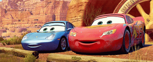 Two Cars From The Movie Cars Are Standing Next To Each Other GIF