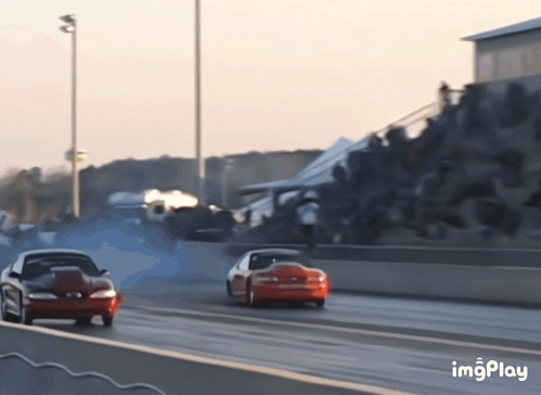 Two Cars Racing on Track Imgplay